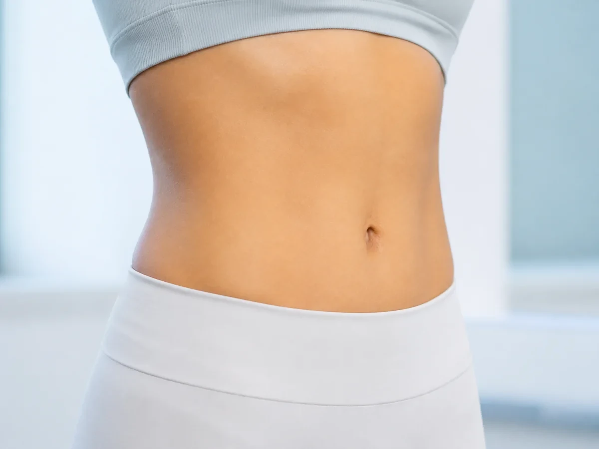 Close-up of an adult woman's waist and abdomen
