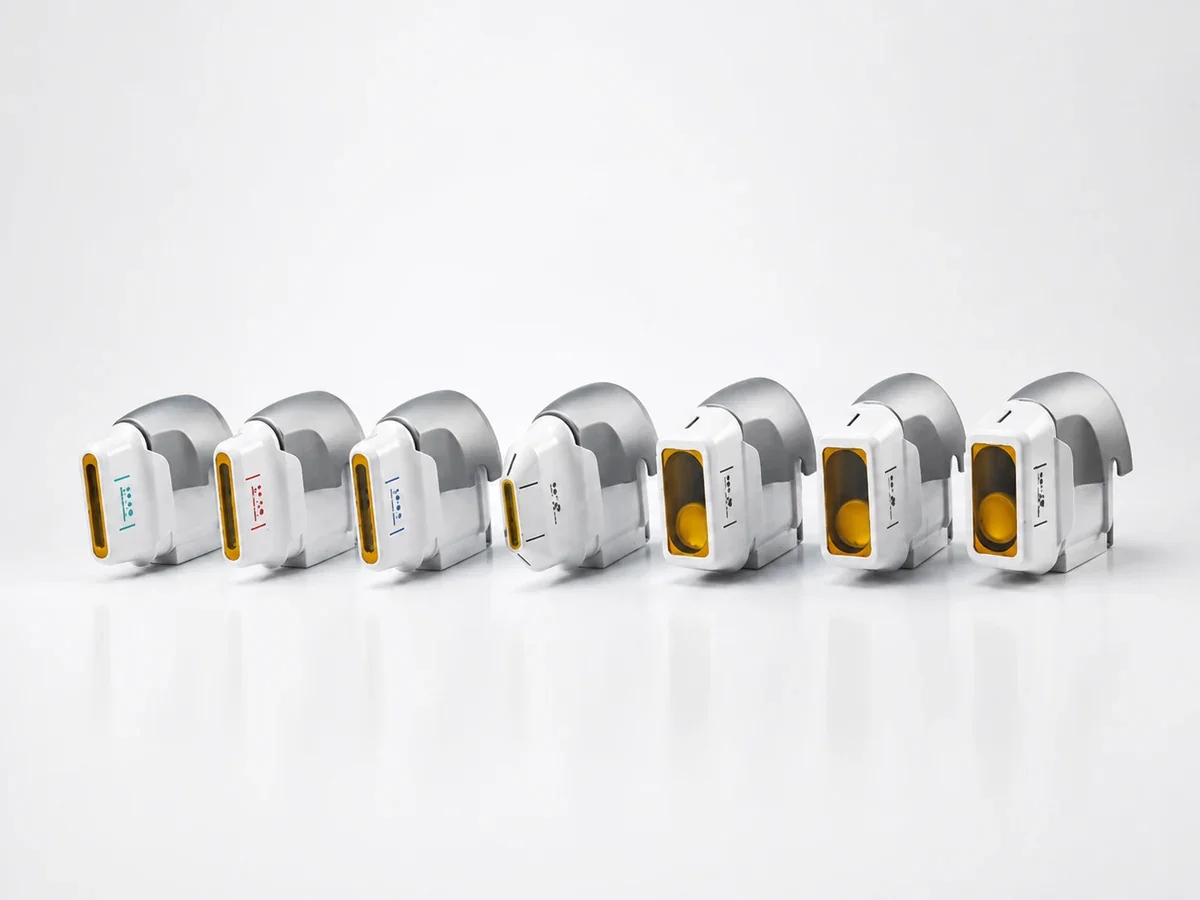 Seven white and gray multi-depth HIFU cartridges arranged in a row